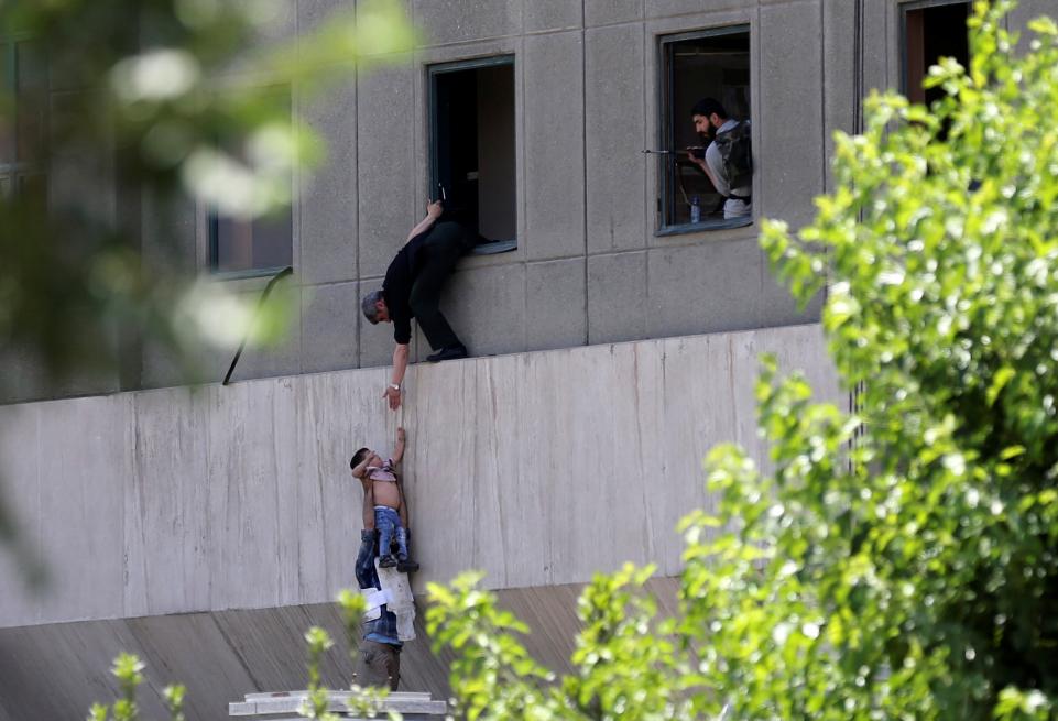 A boy is evacuated during an attack in Tehran