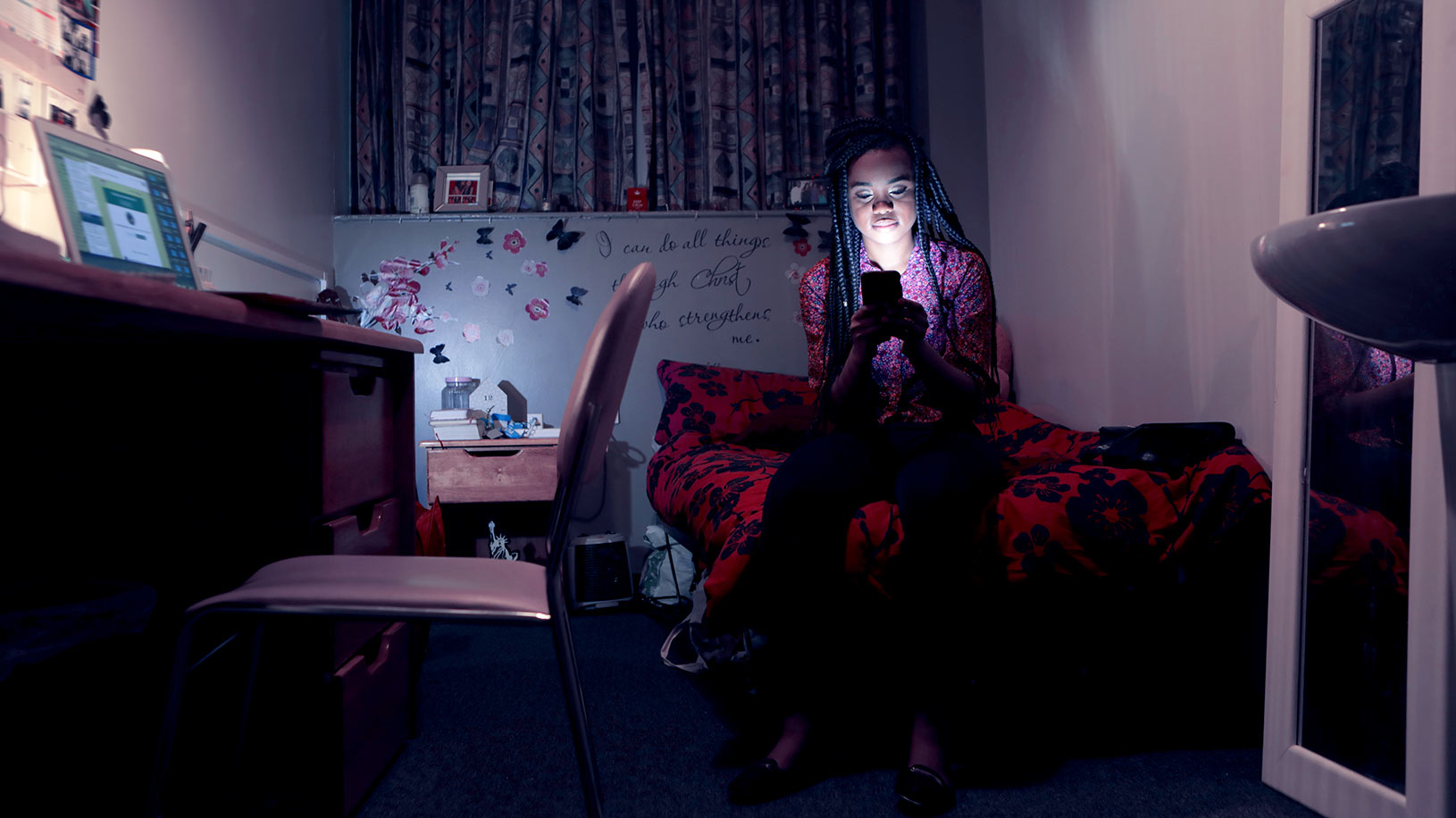 College student on phone in dorm room