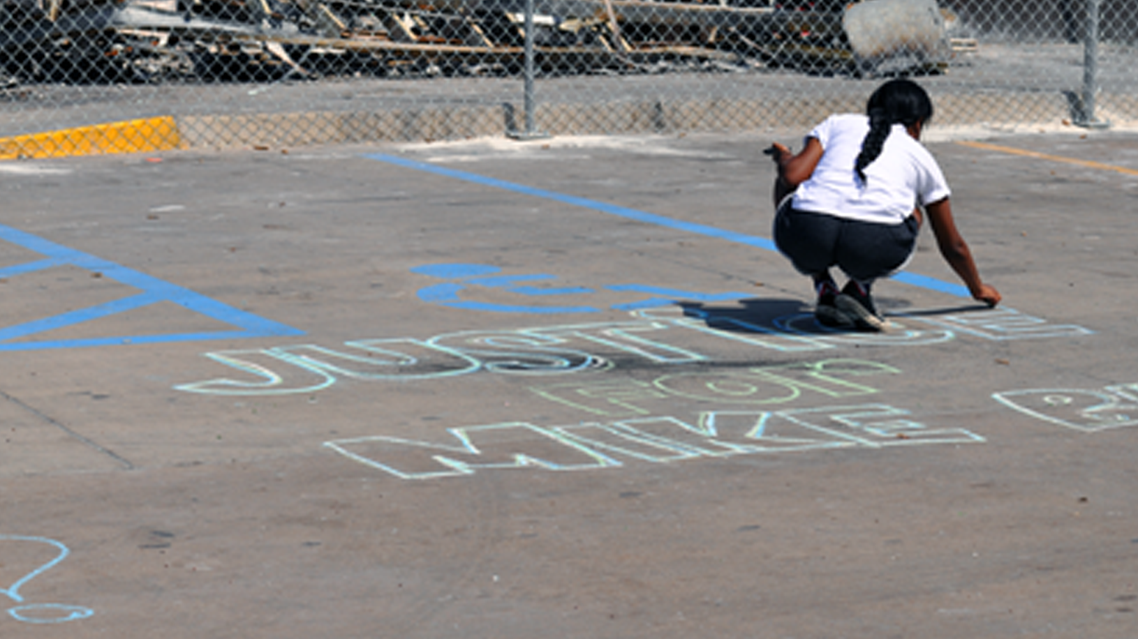 Girl Writes Justice for Mike Brown in Chalk Ferguson Missouri