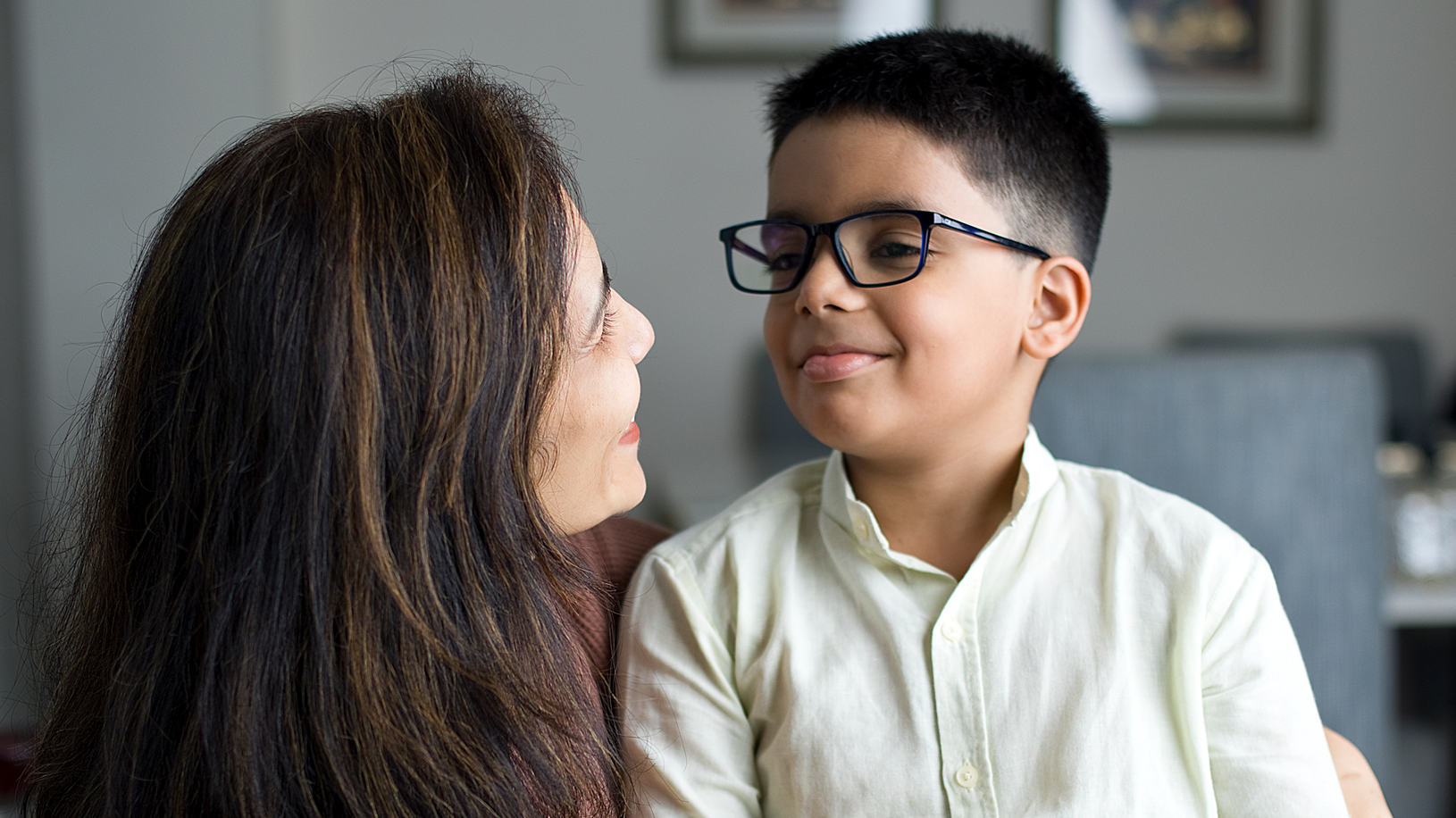 Loving mother embracing son at home