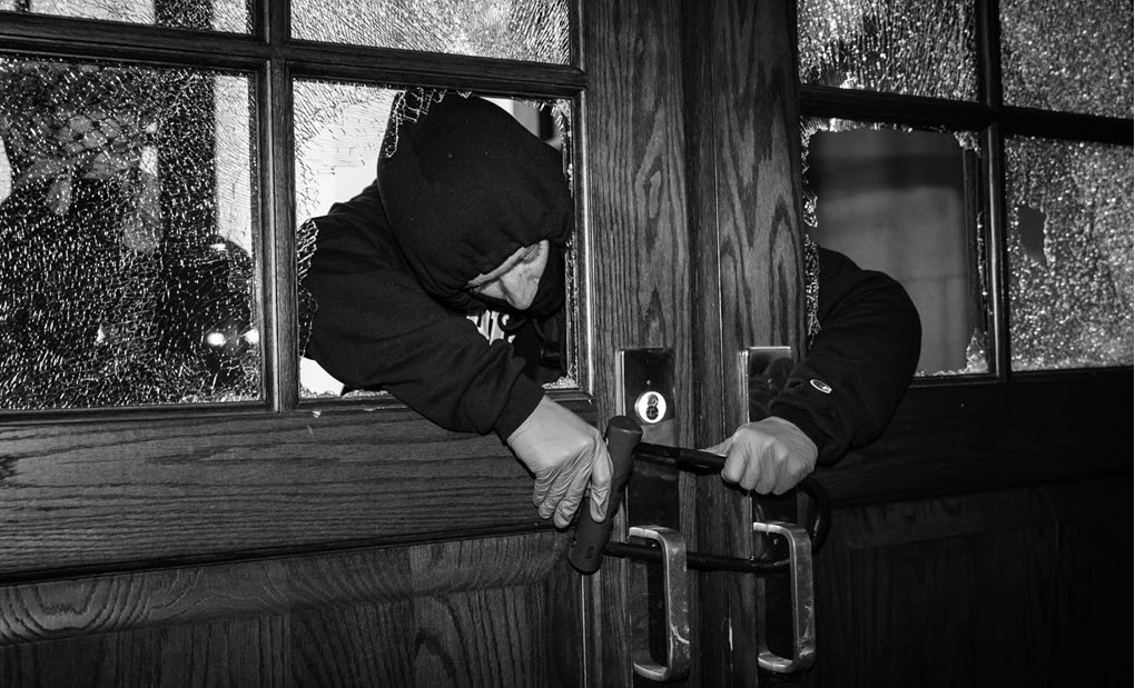 An anti-Israel protester locks the door with a bike lock during the Hamilton Hall takeover at Columbia University in New York, NY on April 30, 2024