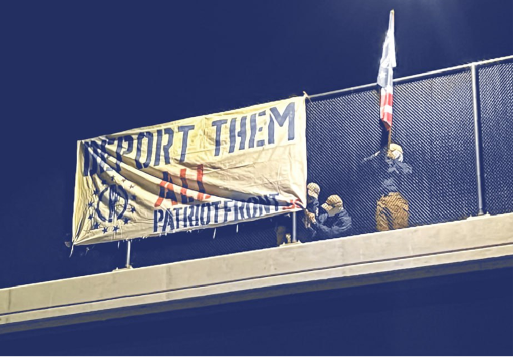 In March 2024, approximately five individuals associated with Patriot Front held a banner drop over an overpass in Lehi, Utah that read: “Deport Them All.” Source: Telegram. 