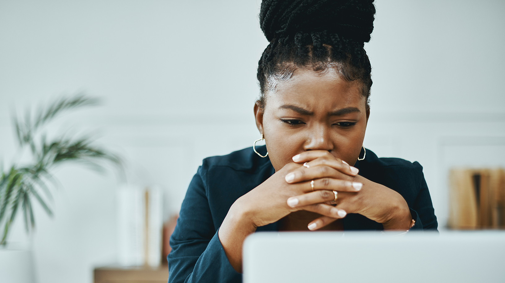 Concerned woman looking at laptop