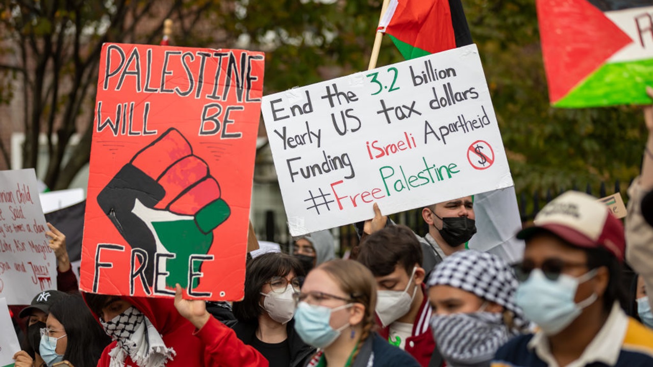 Students from Brooklyn College and supporters hold signs during a pro-Palestinian protest at the entrance of the New York campus on October 12, 2023