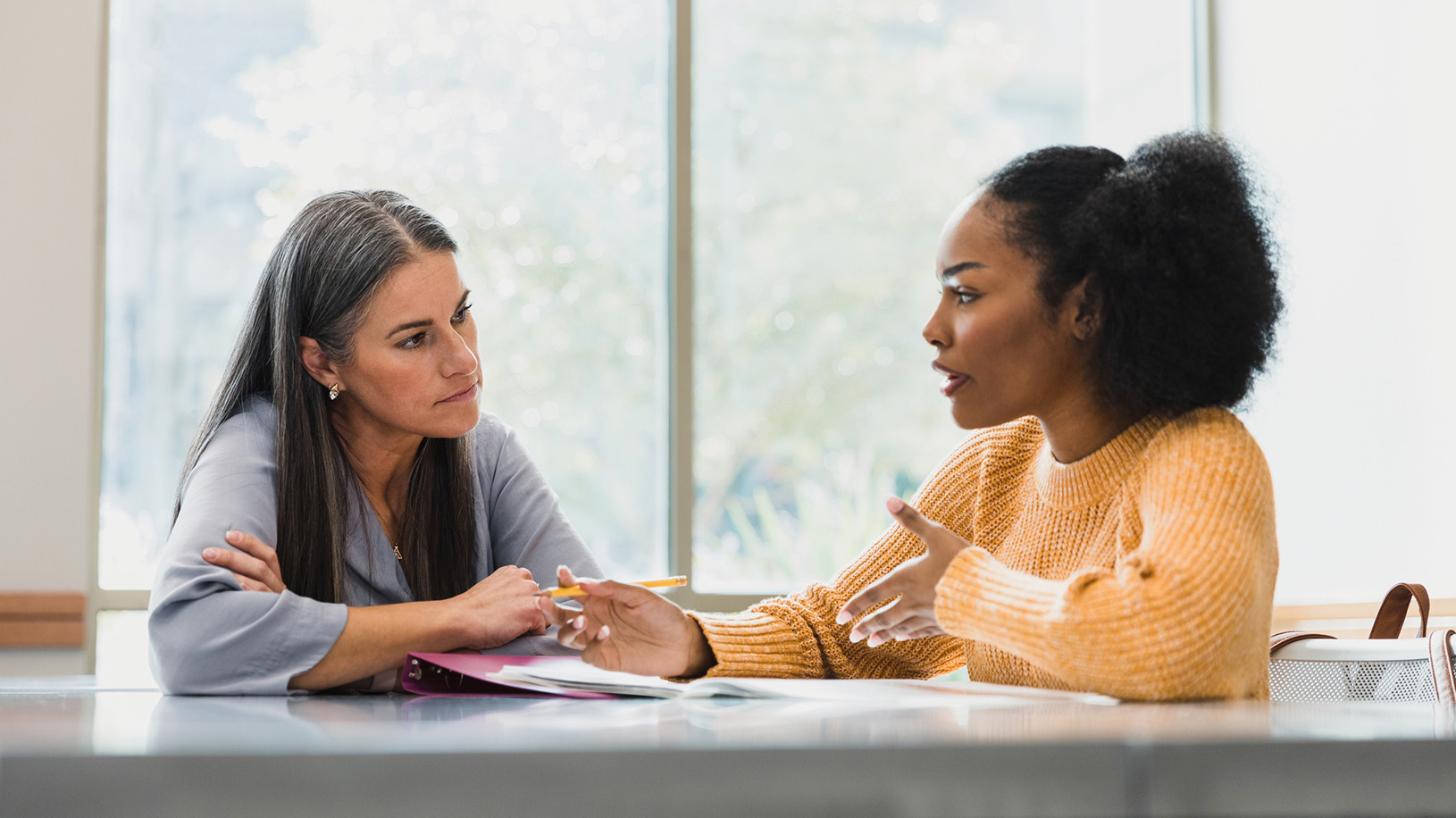 Teacher and College Student Talking