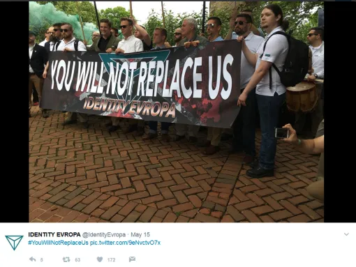 Identity Evropa supporters carry a banner at a march