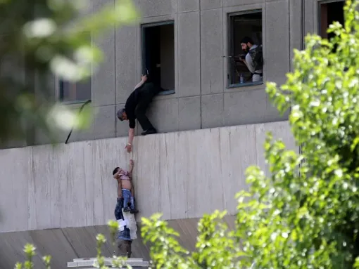 A boy is evacuated during an attack in Tehran