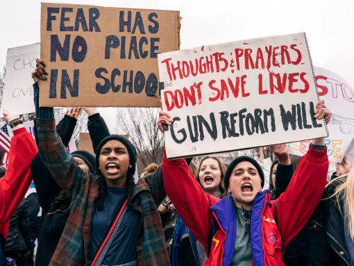 Student Protestors Holding Sign "Thoughts and Prayers Don't Save Lives