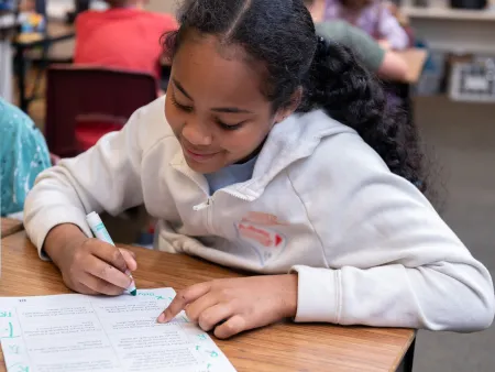 Young girl completing lesson in class